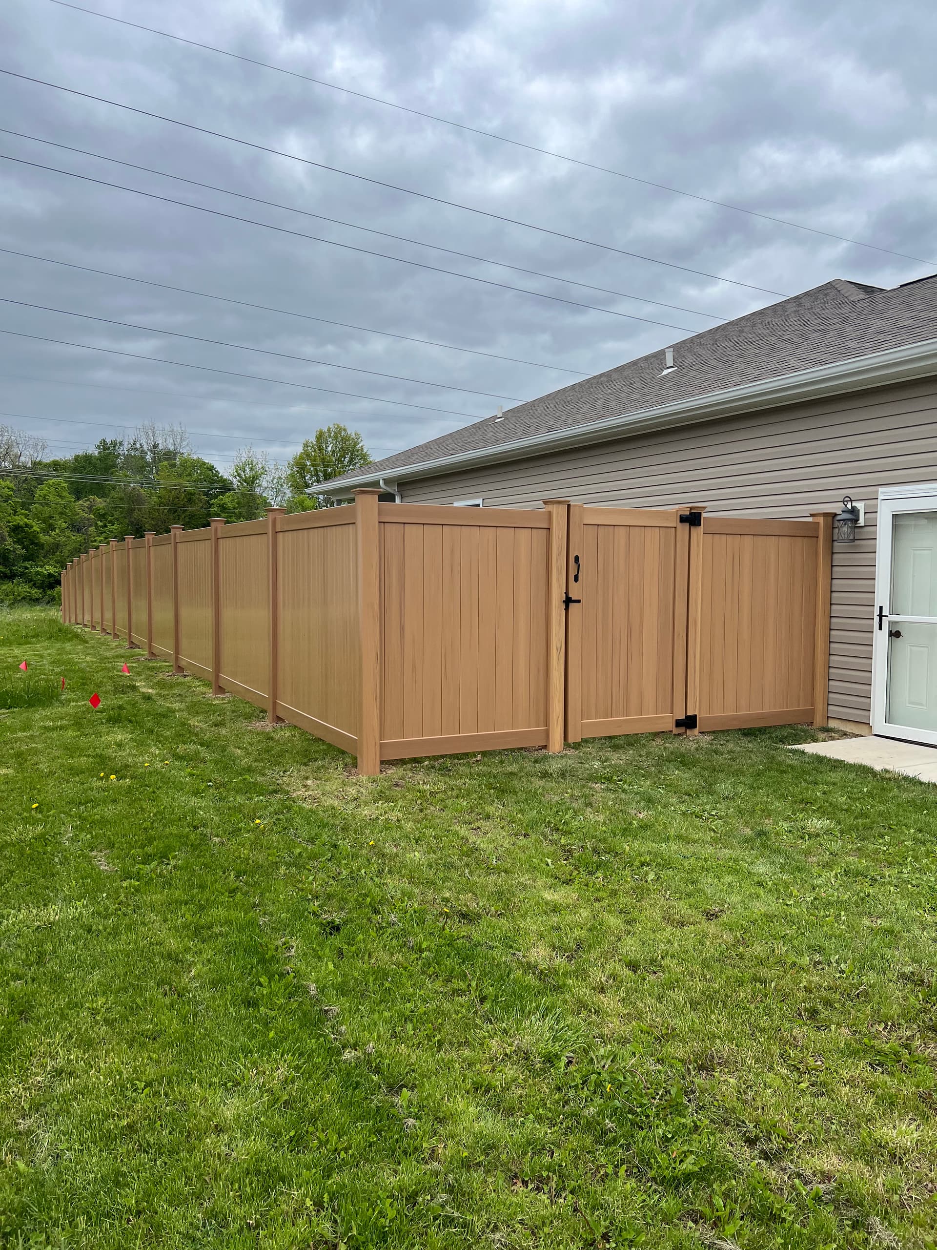 Gallery photos for Cyprus Wood Grain Vinyl Privacy Fence Install in Shawnee: Image #1